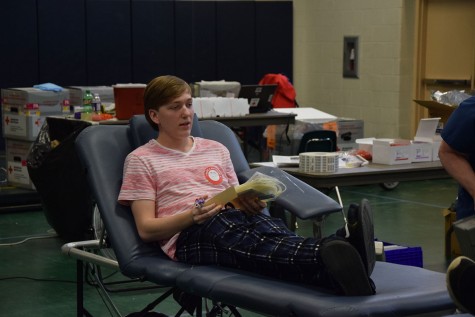 Caleb Story sit in the chair, waiting to get his blood taken. 