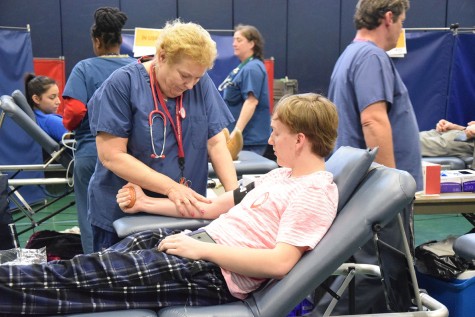 Caleb Story waits while the nurse finds his vein. 