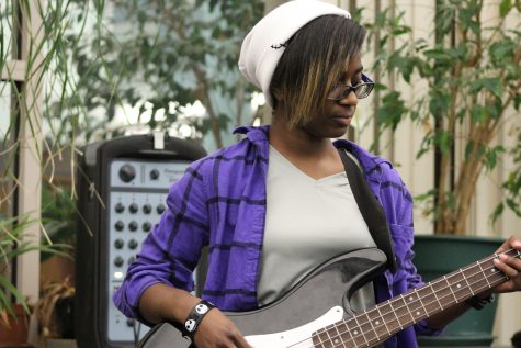 KD Haughton ('19) plays bass along to a song on her phone.