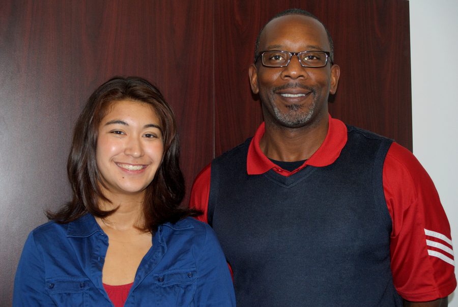 Natalie Burlew (19), semifinalist in the National Merit Scholarship competition, stands by Principal Gregory Daniel.