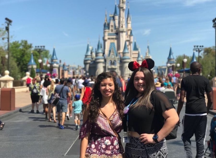 Caitlynn Holmes and Zoreli Simien embracing in front of Cinderellas Castle on Main Street USA. 