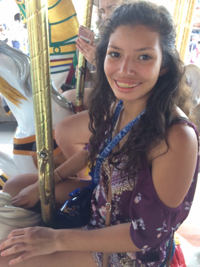 Zoreli Simien on the Prince Charming Regal Carousel in Magic Kingdom.  