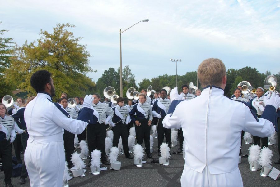 Both drum majors conduct the band at the Talon Tailgate. 