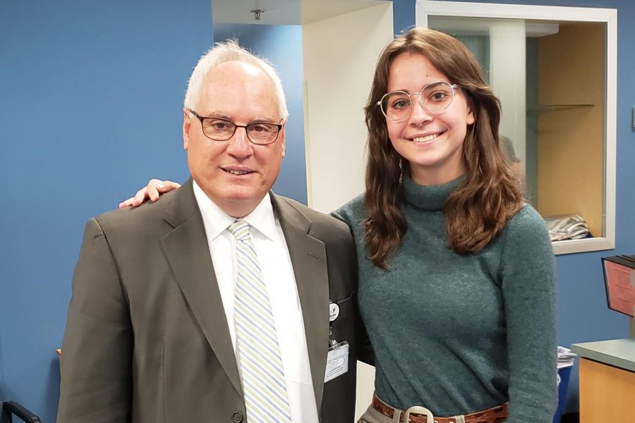 Superintendent Scott Kizner poses with reporter Aynsleigh Escher (20).