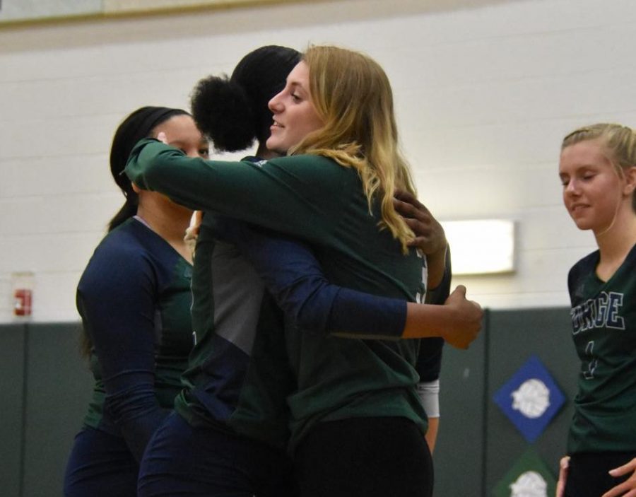 Bailee Walker (12) hugs Simone Newell (12) during a game.