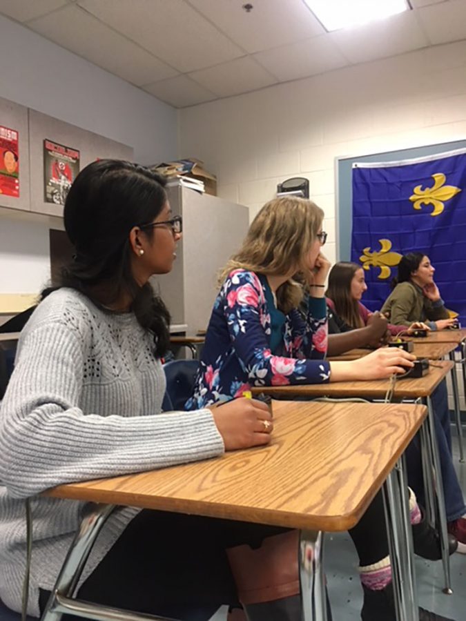 Amrutha Obbineni (19) and Teah Snively (19) listen to the trivia questions being asked during practice.