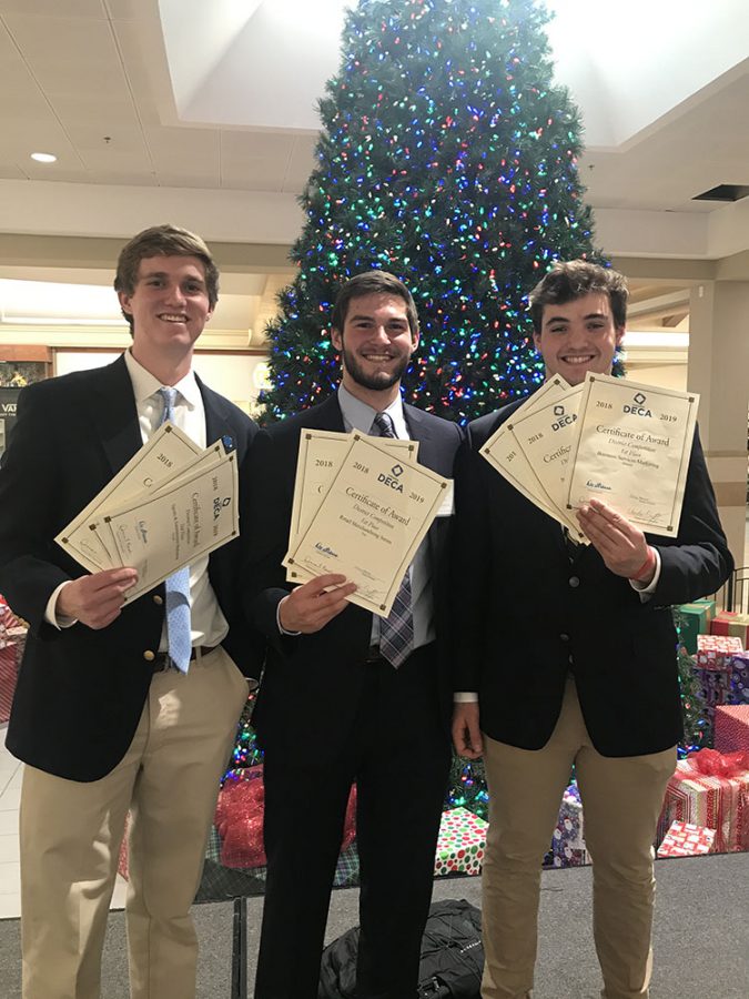 David Weekman (19) with Steven Dean (19) and Matthew Hickey (19) at a district level DECA competition.