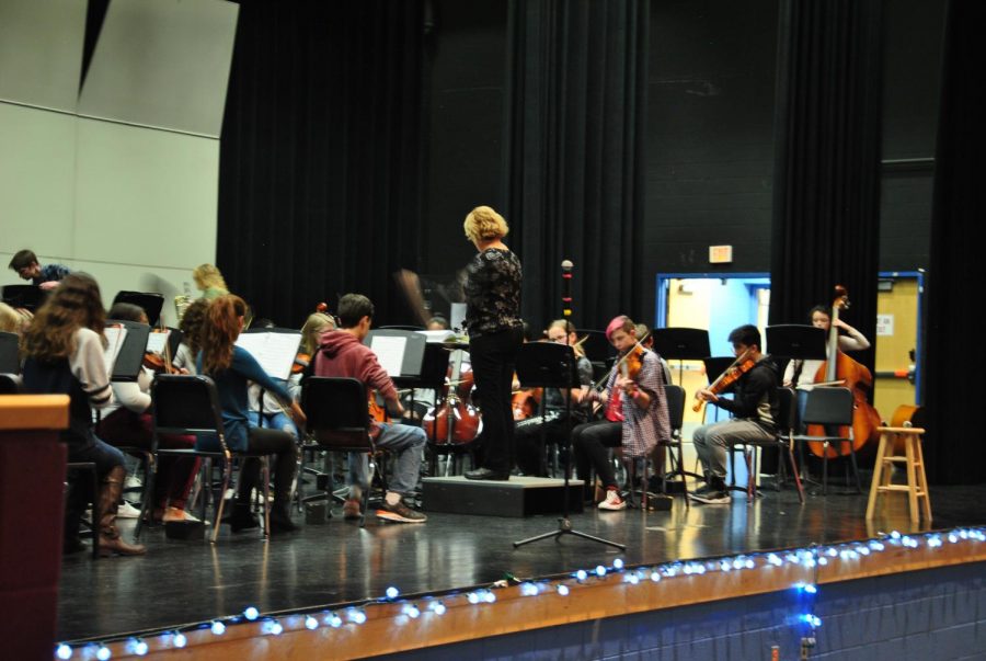 Ms. Tripp conducts her class as they play their instruments.