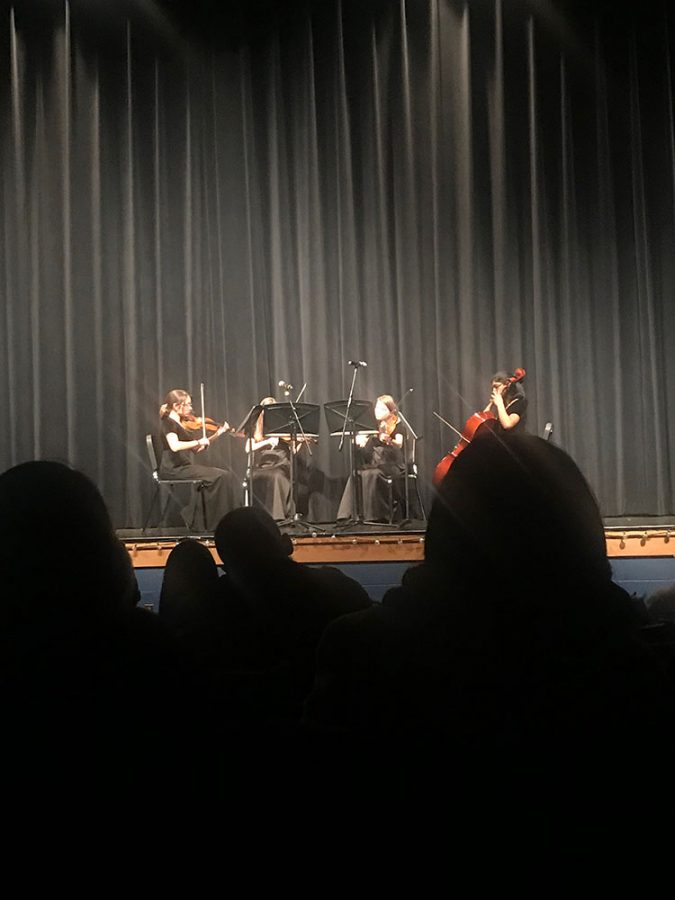 Prior to the winter orchestra concert (20) Camila Reyes Rios, (21) Jaime Erfurdt , (21) Jenna Erfrudt , and (21) Nithya Gottipati play. They were performing Flight Quartet.