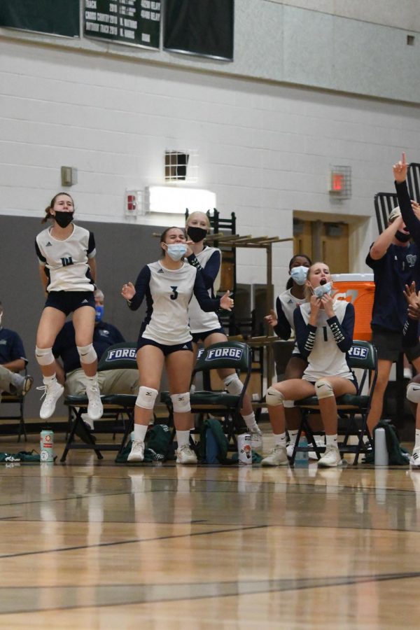 Ashley Stafira ('25), Evengely Terjera ('23), and Maddie Stachelek ('22) cheering on their teammates. Photo: Marissa Hamlett.