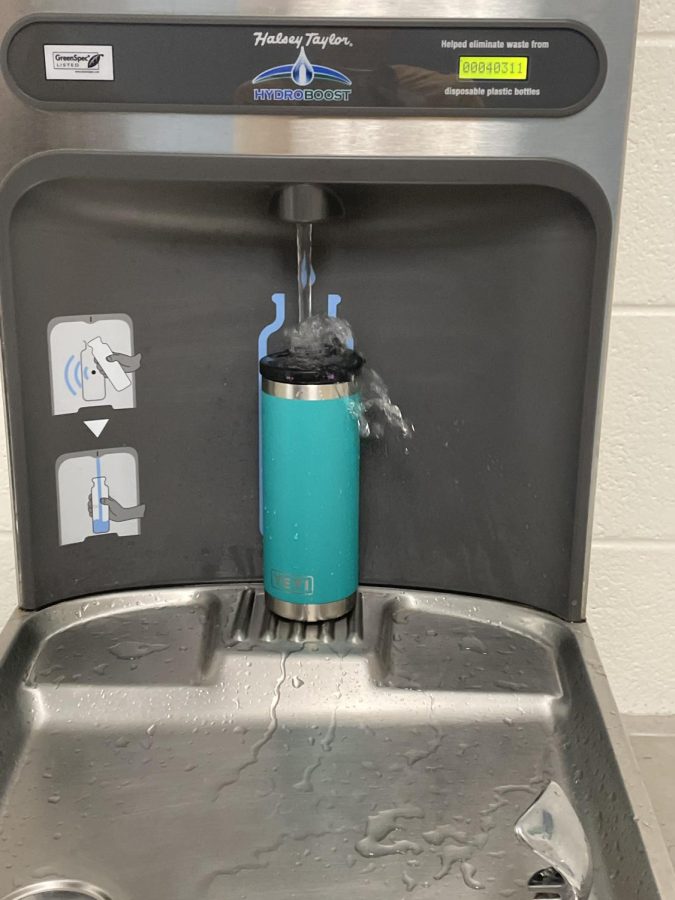 One of the reopened water stations getting back to work, filling up students water bottles.