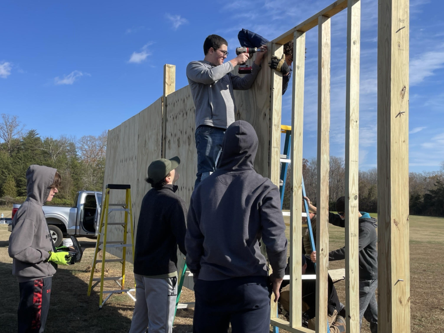 Boy Scouts, football players, and lacrosse players all chip-in during the service project construction.