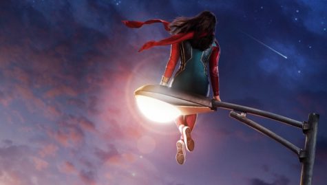 Ms. Marvel sitting atop a lamppost; promotional banner