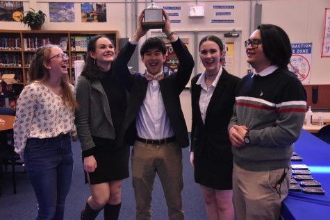 Kaitlyn Halepaska (‘25), Lucy Gentry (‘24), Kyle Nguyen(‘23),
Charlotte Vorder Bruegge (‘24), Gabriel Octavio (‘23) laugh after Kyle Nguyen triumphantly raises the first place trophy above his head.

