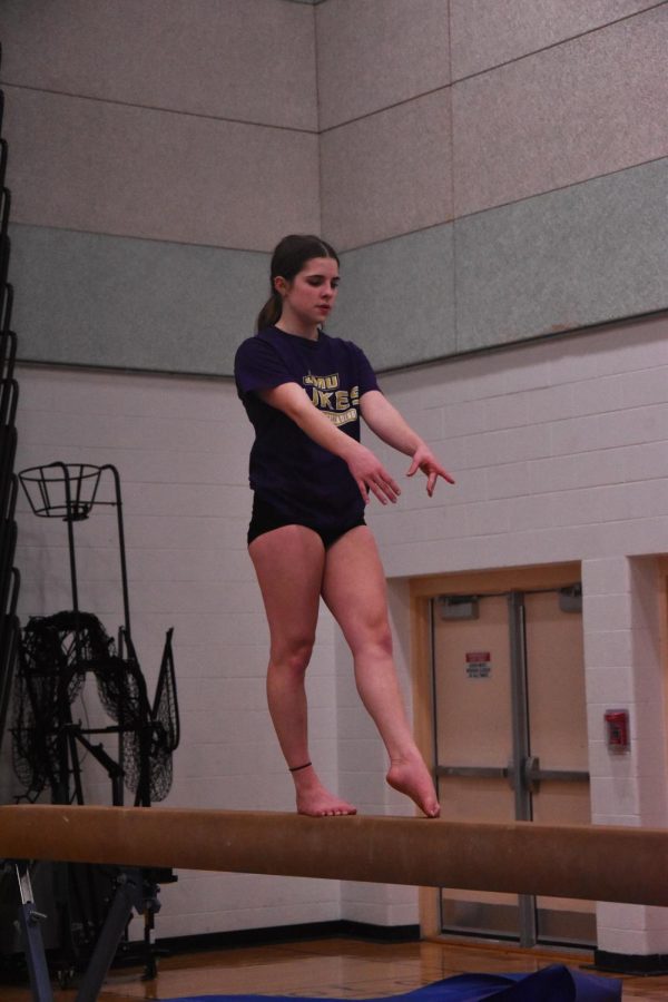 Graceemae focused on beam during gymnastics.