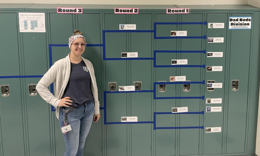 Mrs.+Taylor+Simpson+standing+next+to+her+Mammal+March+Madness+bracket+in+the+school+halls.