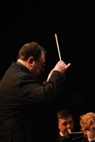 The band director and teacher Mr. Gillette passionately conducted, pinkies up, during the last song at the yearly band concert. 