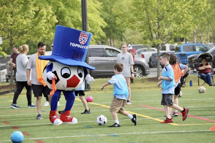 TOPSoccer+mascot+plays+soccer+with+children+and+other+attendees.+Picture+taken+from+Stafford+Soccer+Facebook+page.